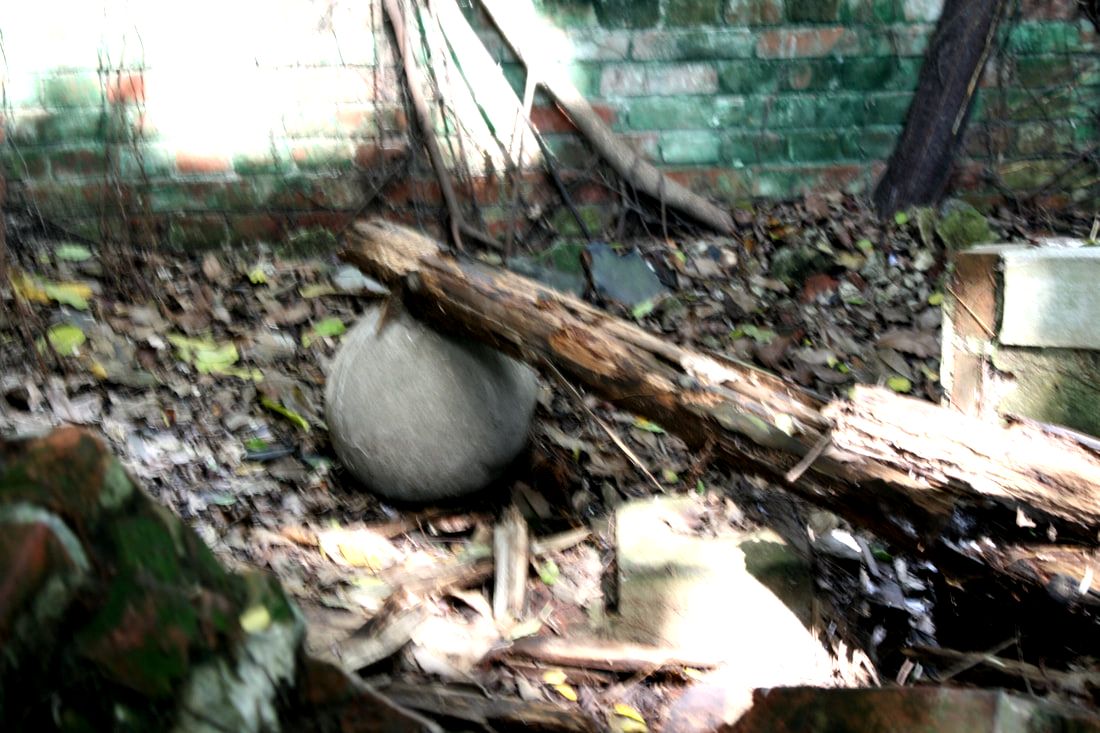 A giant cement ball on the floor, along with some fallen beams. Sorry for the blur. 